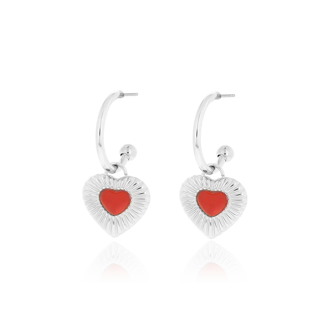 Silver coloured earrings with red heart charm